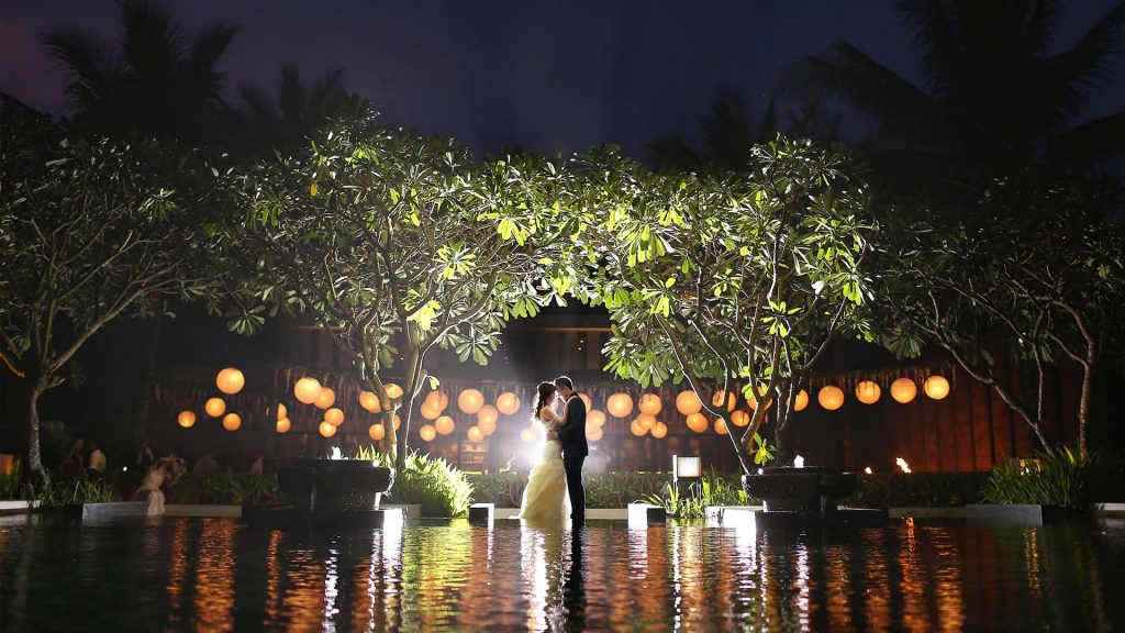 wedding couple, nighttime water reflection, orange lanterns