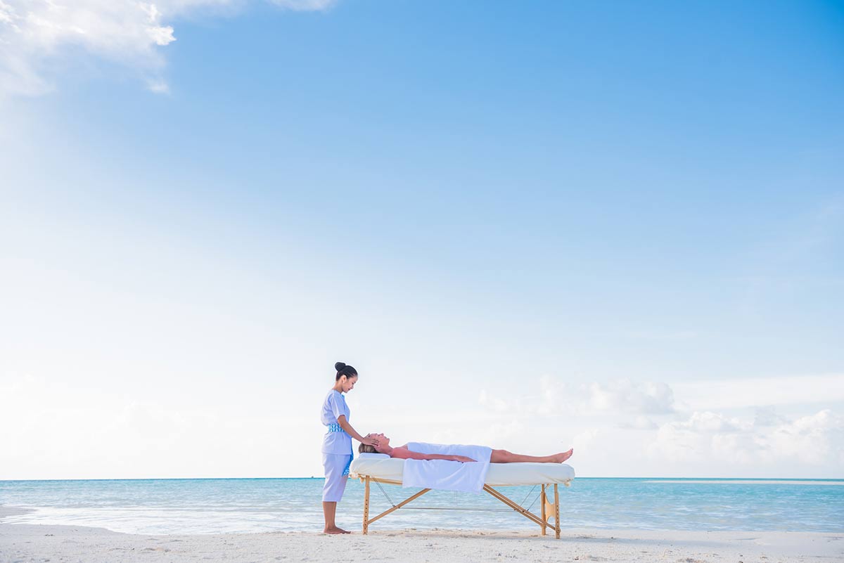 woman getting massage on beach