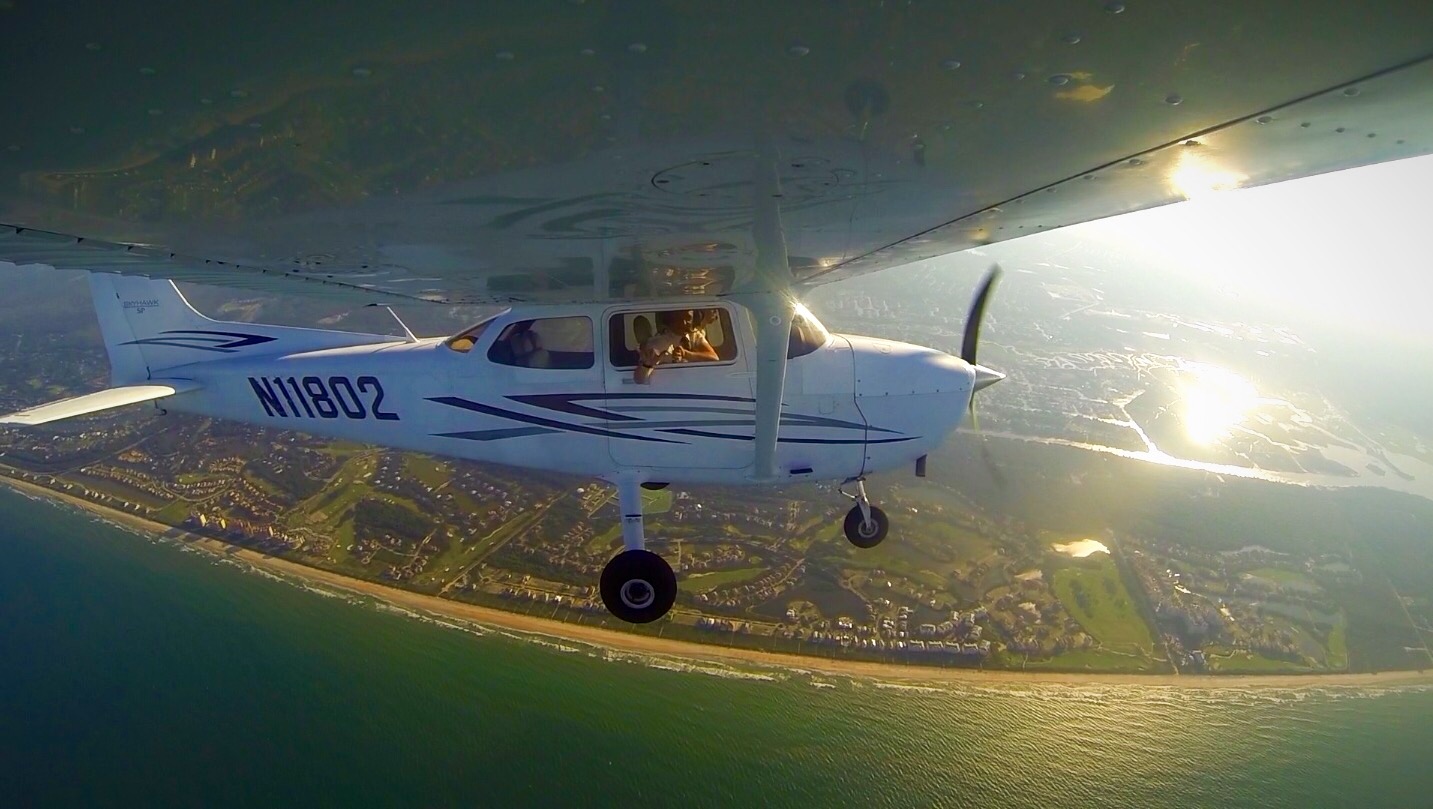 small plane in air over water