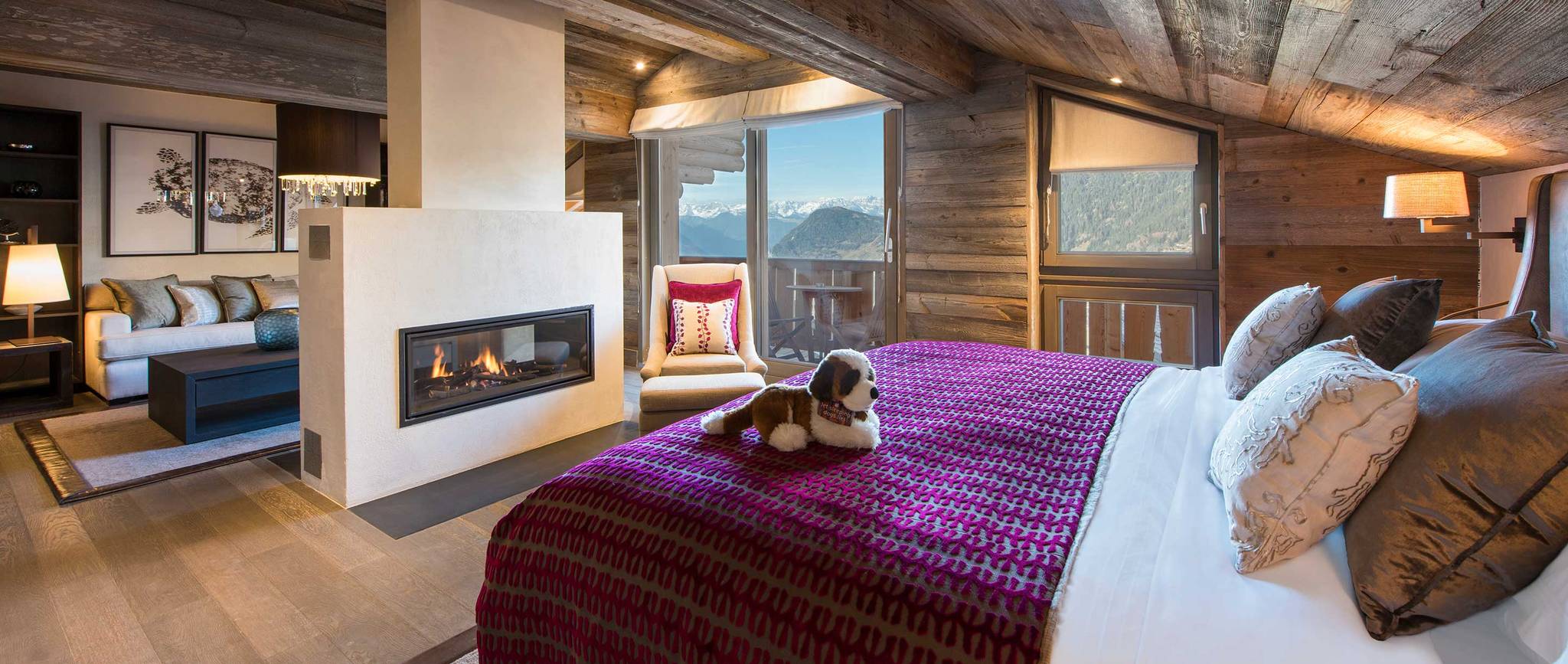 bedroom with toy puppy on bed and fireplace
