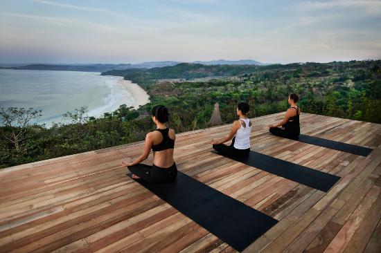 three women on black yoga mats