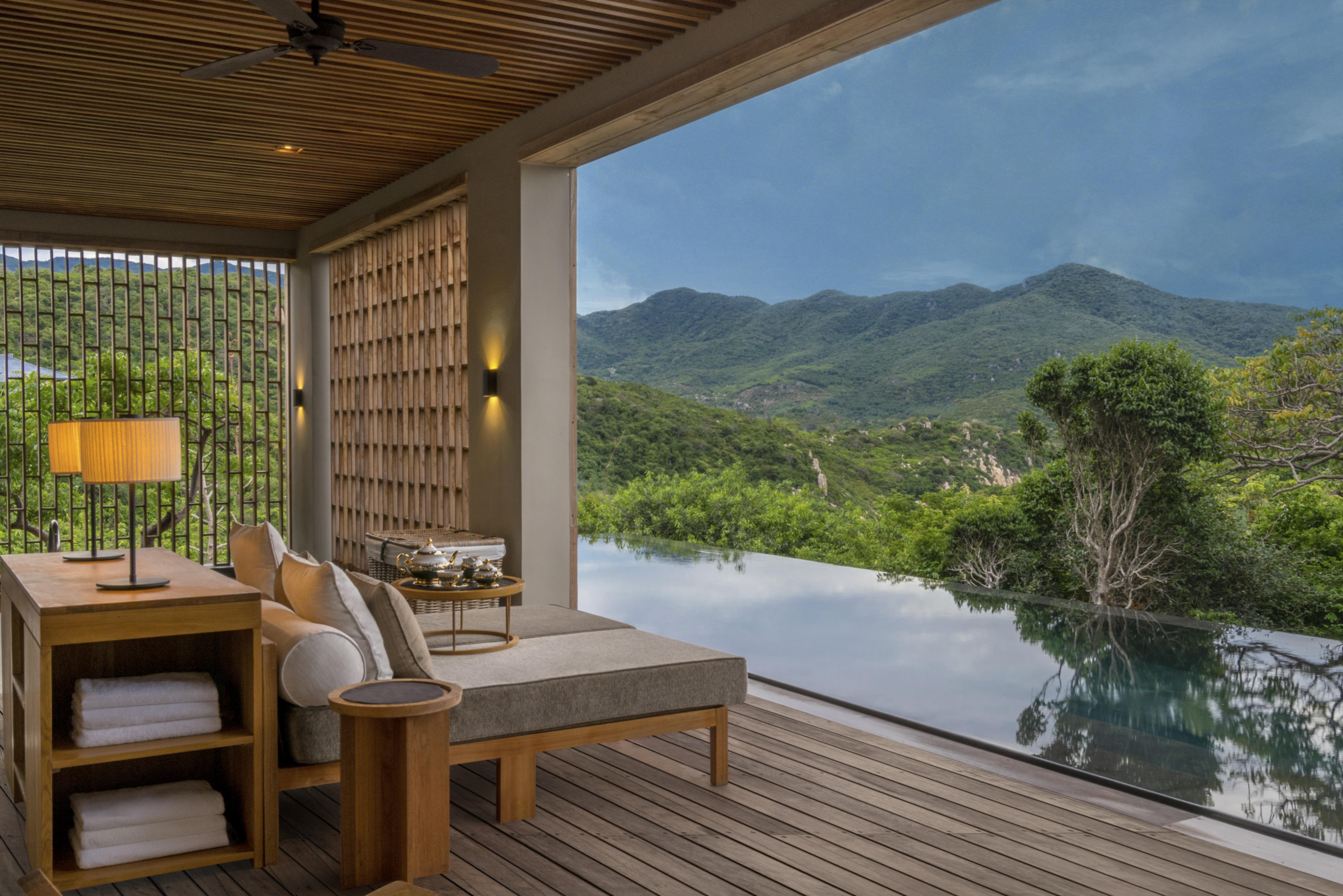 wooden open air seating, overlooking infinity pool and green mountains