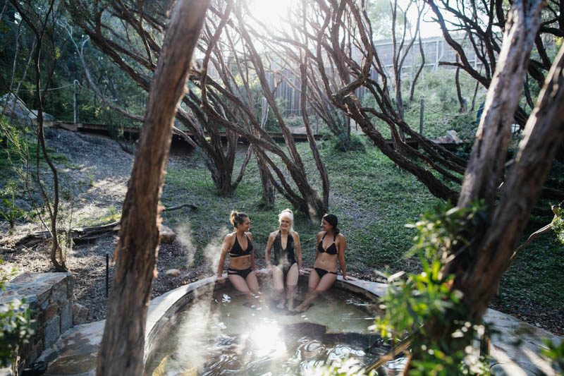 ladies bathing in outdoor mineral pool 
