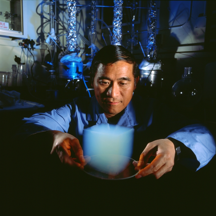 Asian man holding cube of aerogel on plate