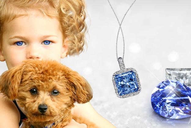 boy holding puppy wth blue gem pendant