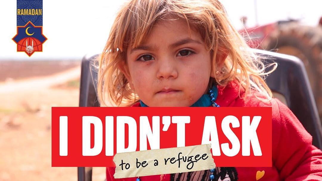 boy with dirty face with the words "I didn't ask to be a refugee" on photo