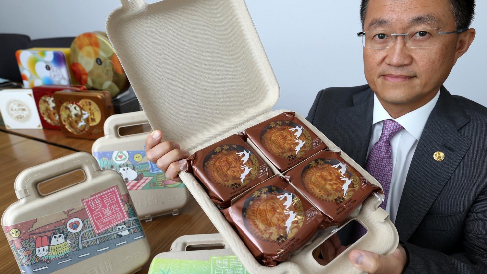 Asian man holding mooncake box open