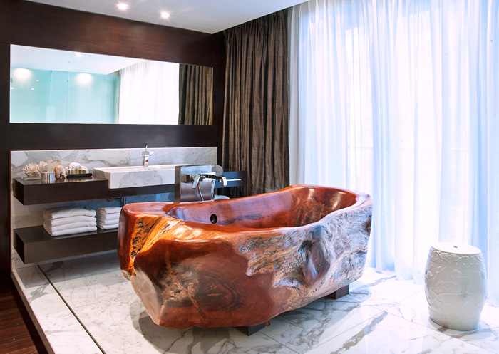 hand-carved wooden bathtub in hotel room