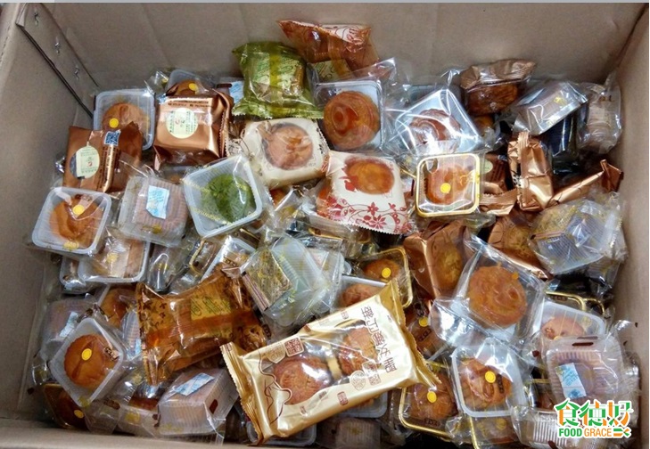 piles of individual cellophane-wrapped mooncakes in a box