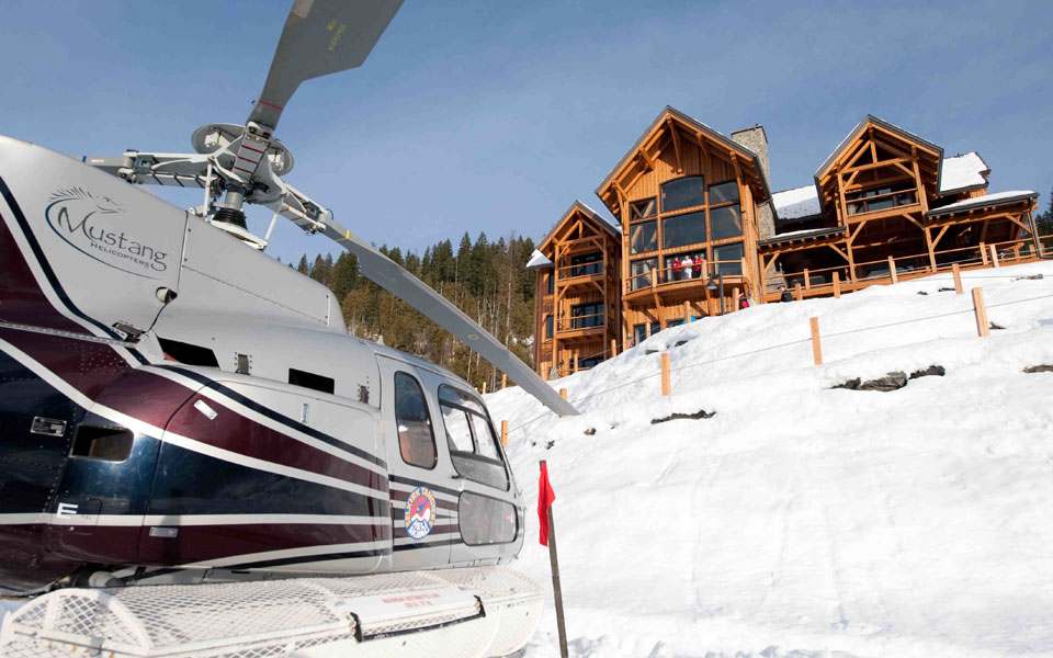 helicopter with ski chalet in background