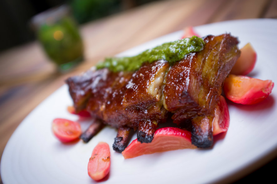 BBQ lamb ribs with fresh chopped herbs over grilled pink beetroot