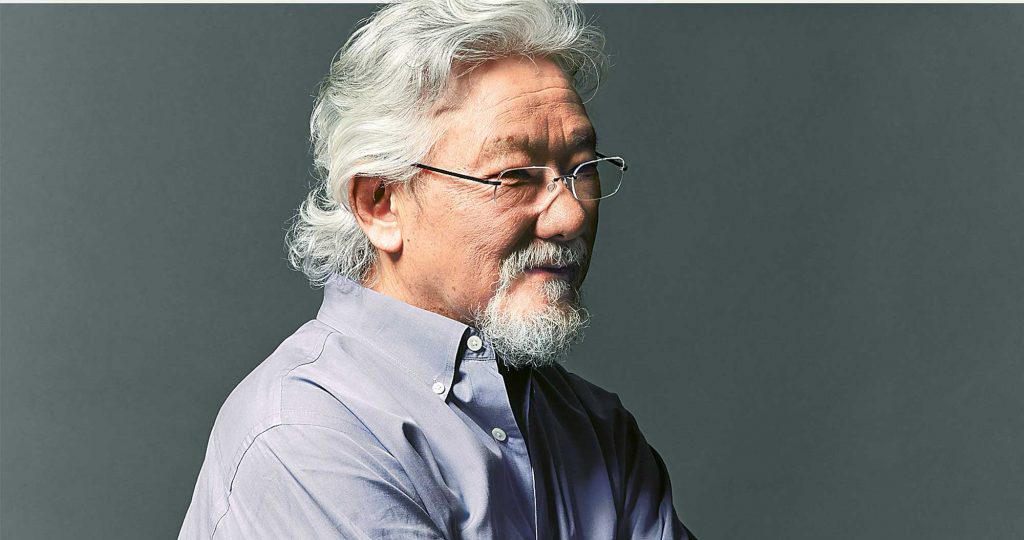 side profile of Dr. David Suzuki wearing glasses and a grey shirt
