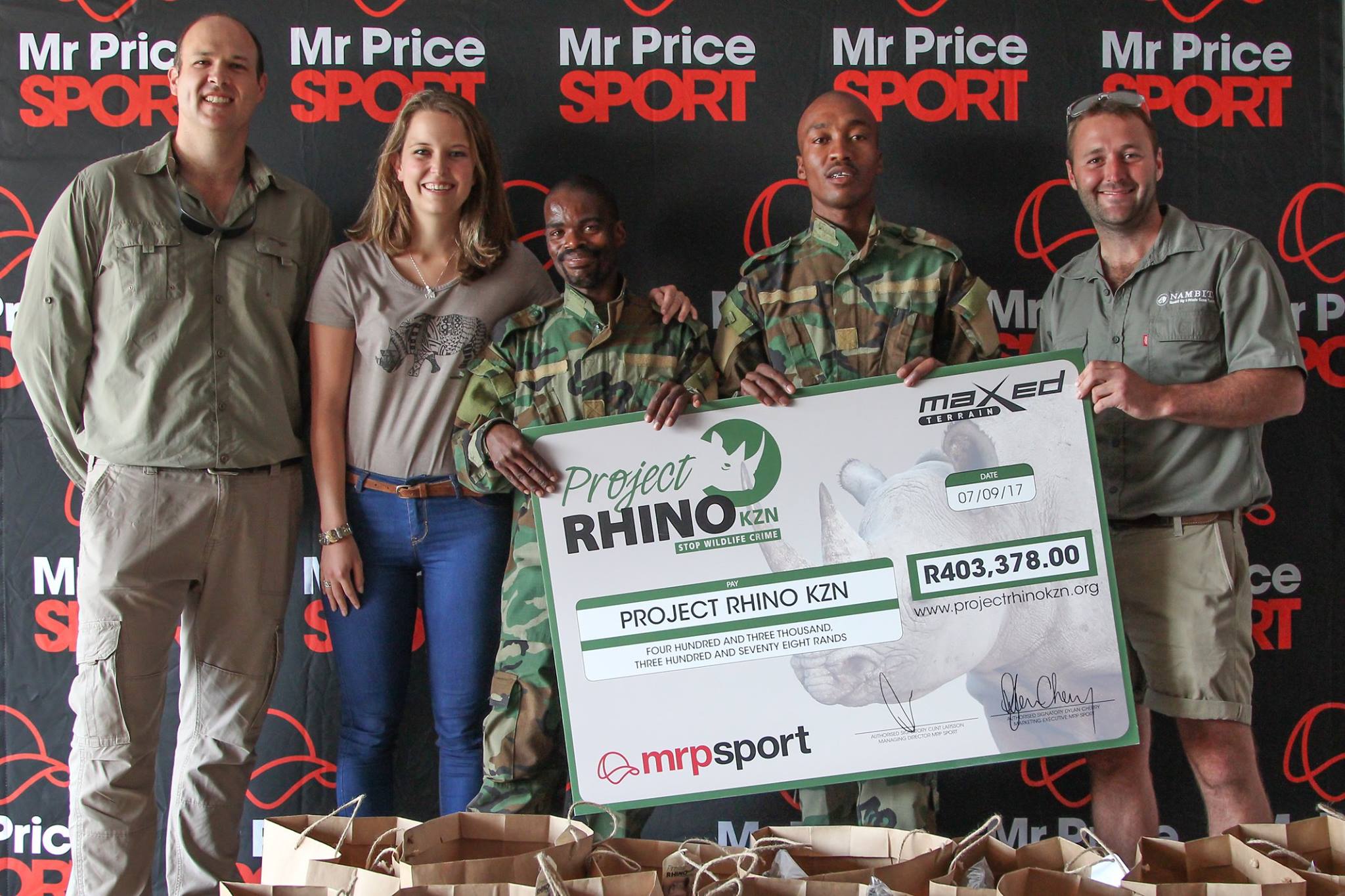 five people holding large Project Rhino donation check