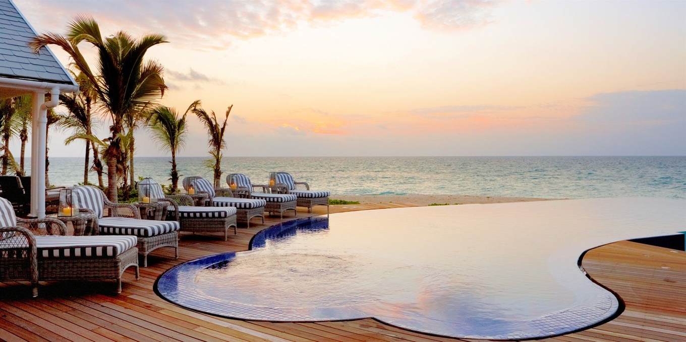 infinity pool overlooking ocean at sunset