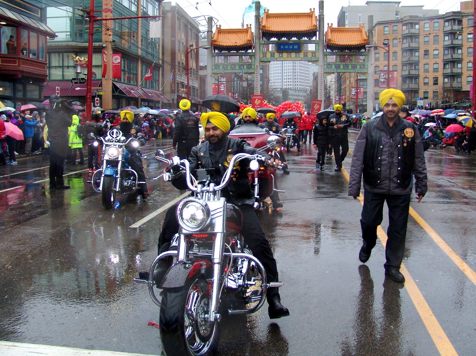 Indian Sikhs wearing yellow turbans on motocycles