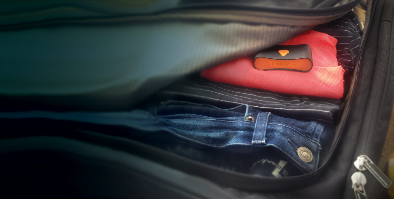 clothes in luggage, orange device on top