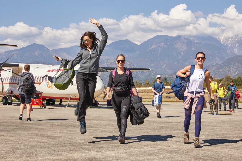 woman walking and jumping, airplane and back ground mountains