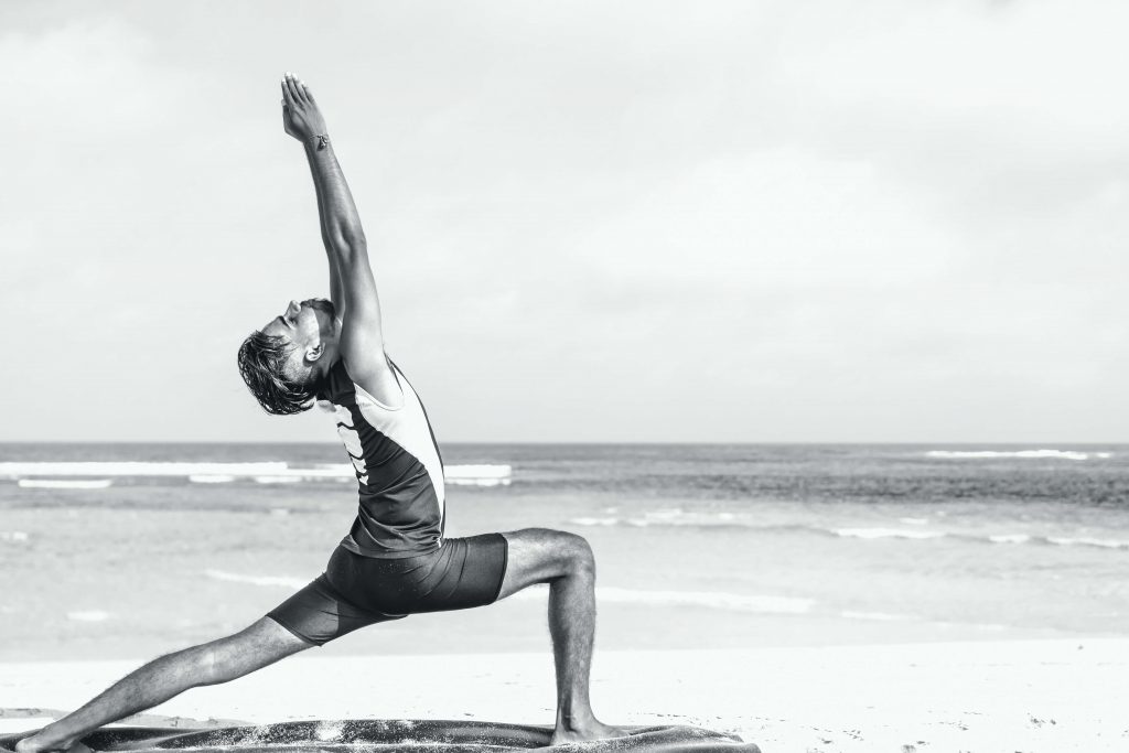 man on beach, yoga pose